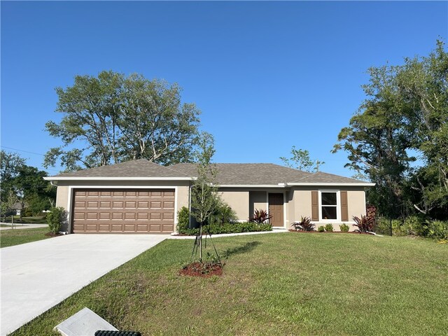 886 Roseland Rd, Sebastian, FL 32958 - ranch-style home featuring a garage, driveway, a front yard, and stucco siding