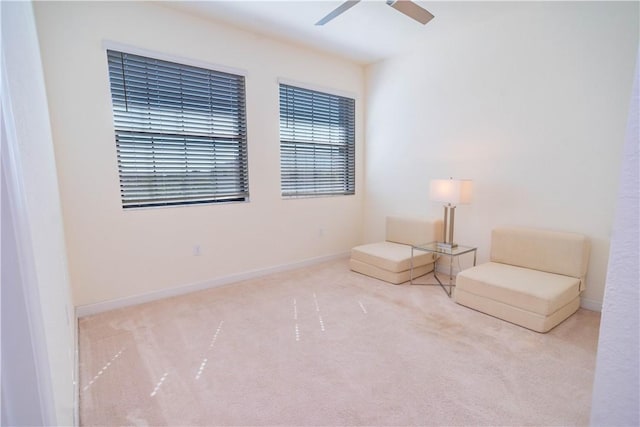 unfurnished room featuring ceiling fan and light carpet