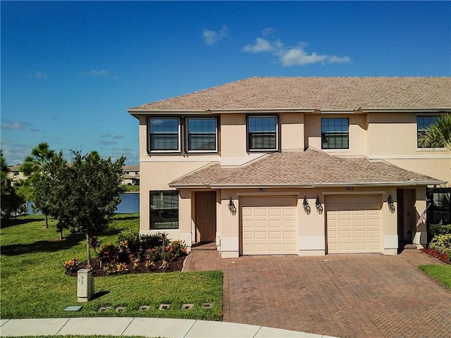 view of front of home featuring a garage and a front lawn