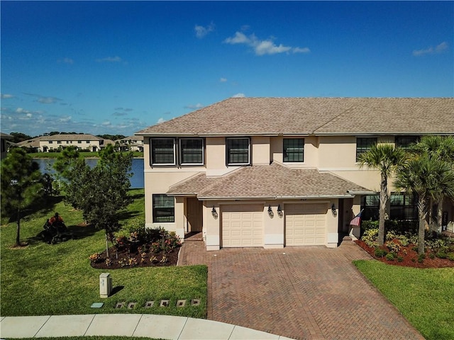 view of front property featuring a front yard and a garage