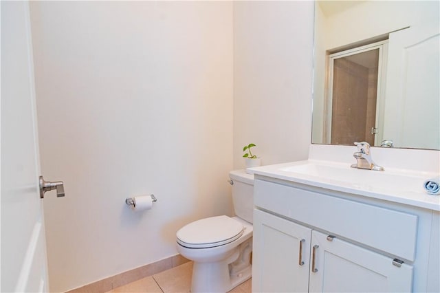 bathroom with tile patterned flooring, vanity, and toilet