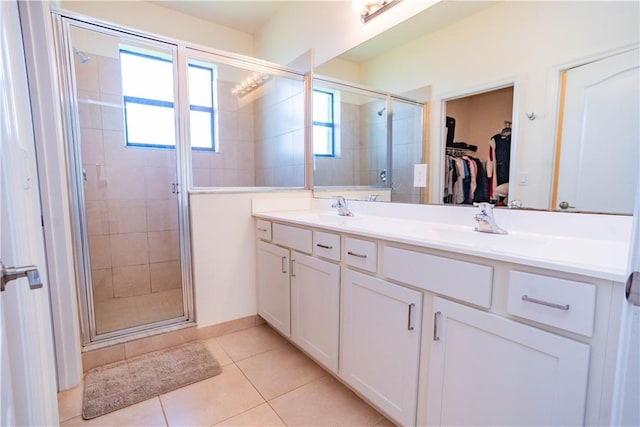 bathroom featuring vanity, tile patterned floors, and a shower with door