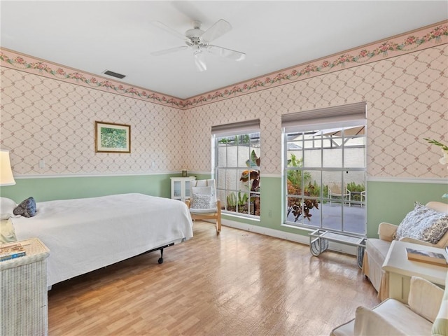 bedroom with light hardwood / wood-style flooring and ceiling fan