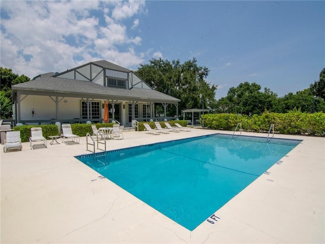 view of pool with french doors and a patio area