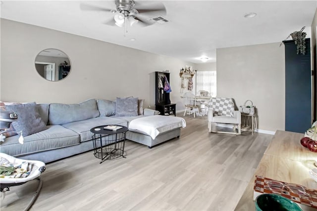 living room featuring hardwood / wood-style floors and ceiling fan