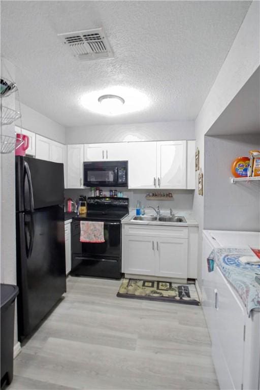 kitchen with white cabinetry, sink, light hardwood / wood-style flooring, and black appliances