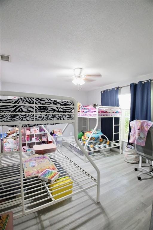 bedroom featuring wood-type flooring and ceiling fan