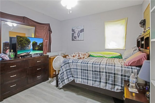 bedroom with ceiling fan and light hardwood / wood-style flooring