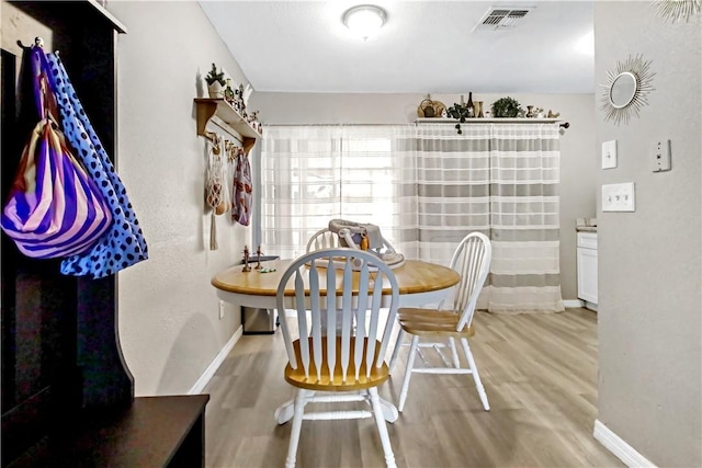 dining area with light hardwood / wood-style floors