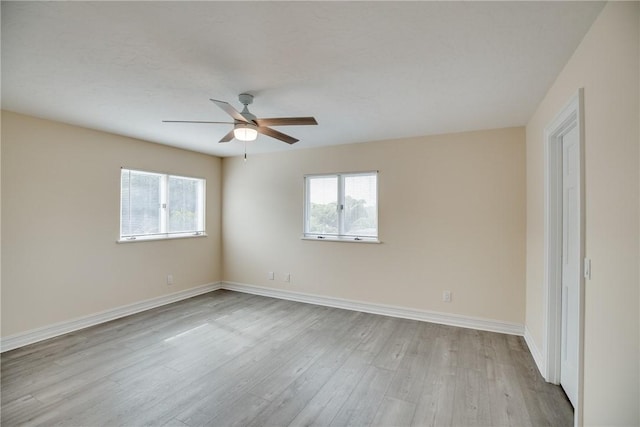 spare room featuring ceiling fan and light hardwood / wood-style floors