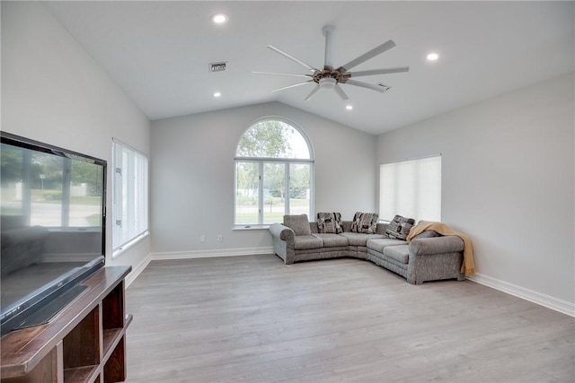 living room with lofted ceiling, ceiling fan, and light hardwood / wood-style flooring