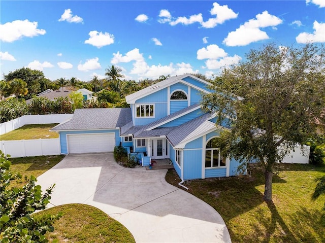 view of front of property with a garage and a front lawn