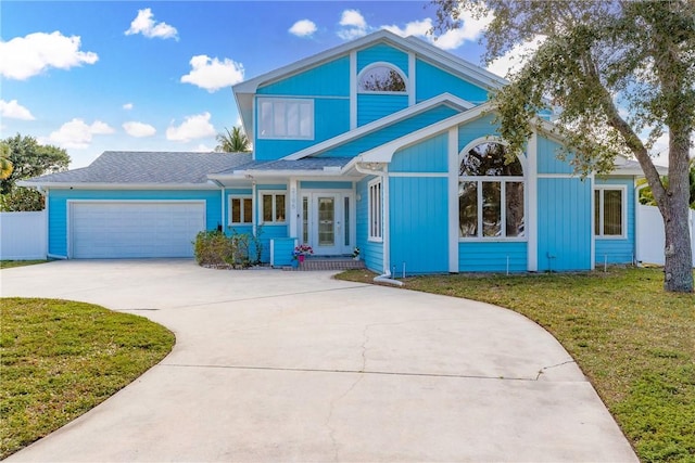 front of property featuring a front lawn and a garage