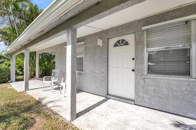 entrance to property with a patio