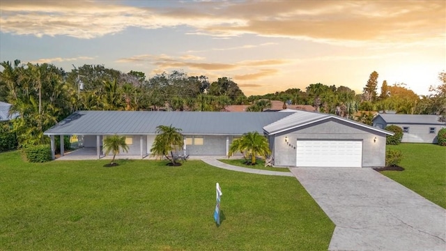 single story home featuring a yard and a garage