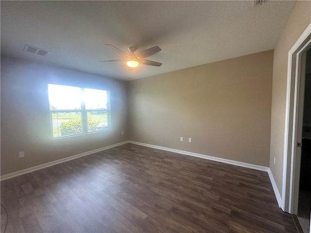 3315 Rockport St SW, Vero Beach, FL 32968 - empty room featuring a ceiling fan and dark wood-style flooring