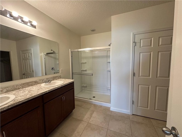 3315 Rockport St SW, Vero Beach, FL 32968 - full bath with a shower stall, double vanity, a textured ceiling, and tile patterned floors
