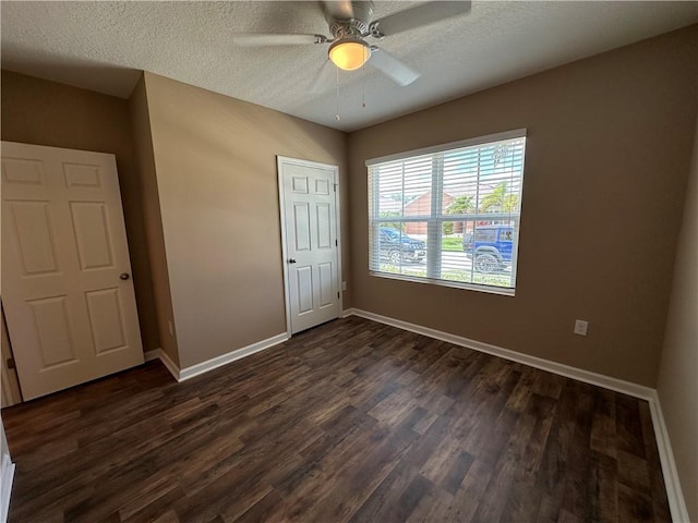 3315 Rockport St SW, Vero Beach, FL 32968 - unfurnished bedroom featuring dark wood-style flooring, a textured ceiling, and ceiling fan