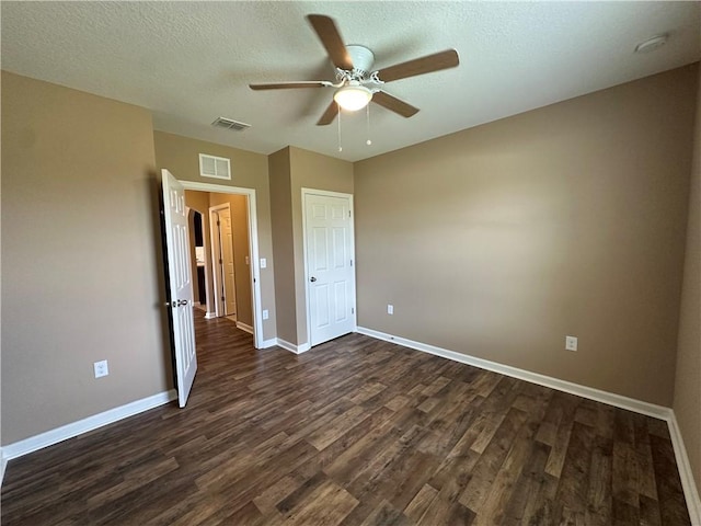 3315 Rockport St SW, Vero Beach, FL 32968 - unfurnished bedroom featuring dark wood-type flooring, ceiling fan, and a textured ceiling