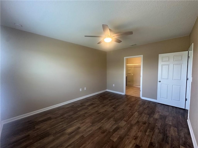 3315 Rockport St SW, Vero Beach, FL 32968 - unfurnished bedroom with dark wood finished floors, ceiling fan, and connected bathroom