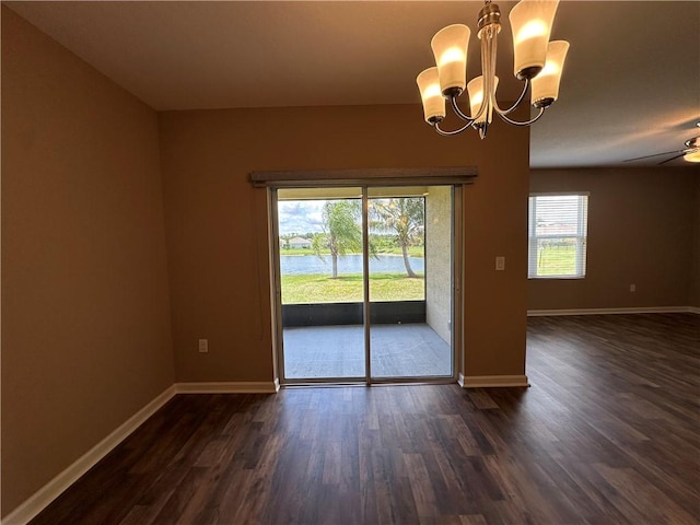 3315 Rockport St SW, Vero Beach, FL 32968 - unfurnished room with dark wood-style floors, a chandelier, and ceiling fan