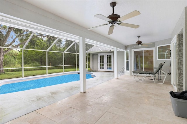 outdoor pool featuring glass enclosure, ceiling fan, a patio, and french doors