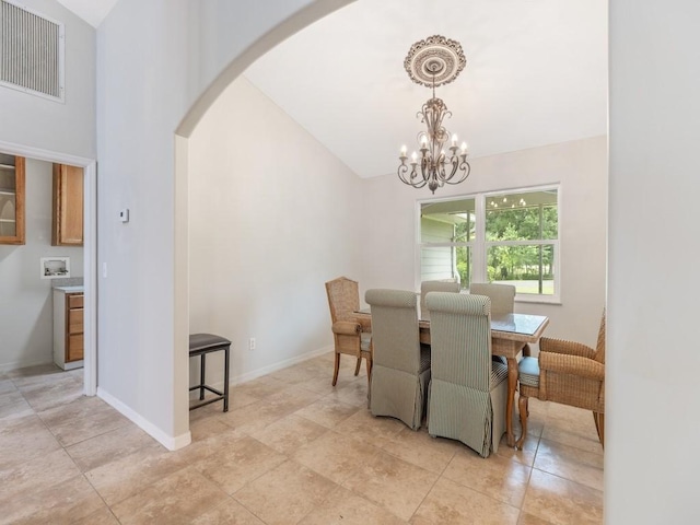 dining room featuring lofted ceiling and a chandelier