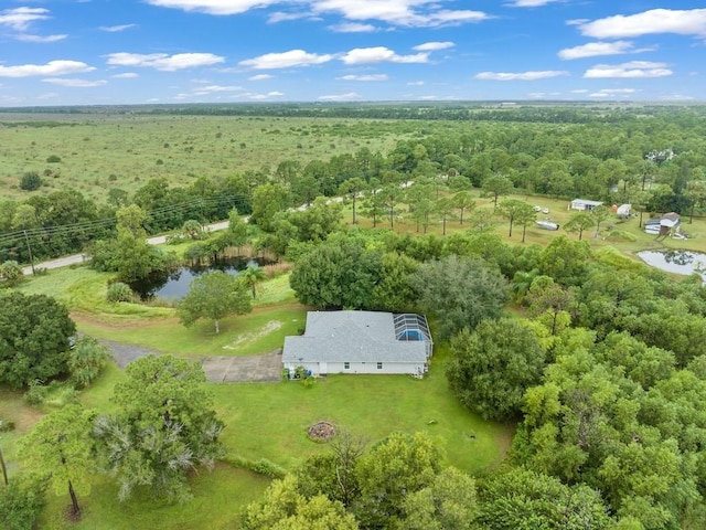 birds eye view of property featuring a wooded view