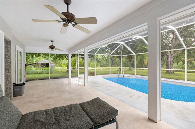 living room with lofted ceiling, ceiling fan with notable chandelier, and light tile patterned flooring