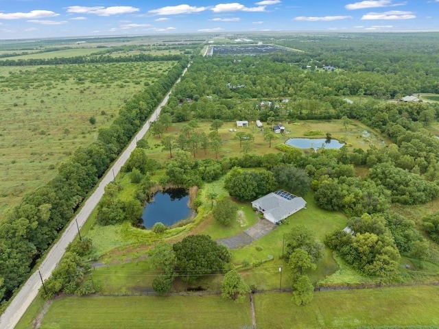 birds eye view of property featuring a rural view and a water view