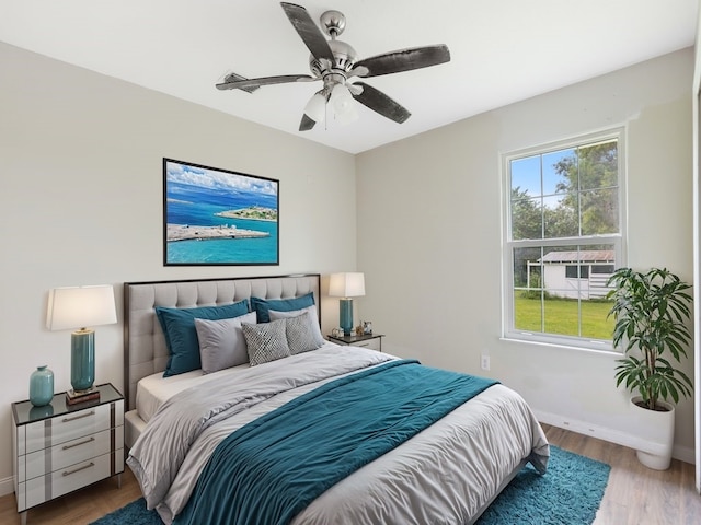 bedroom with ceiling fan and hardwood / wood-style floors