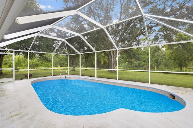 view of pool with a yard, a lanai, and a patio