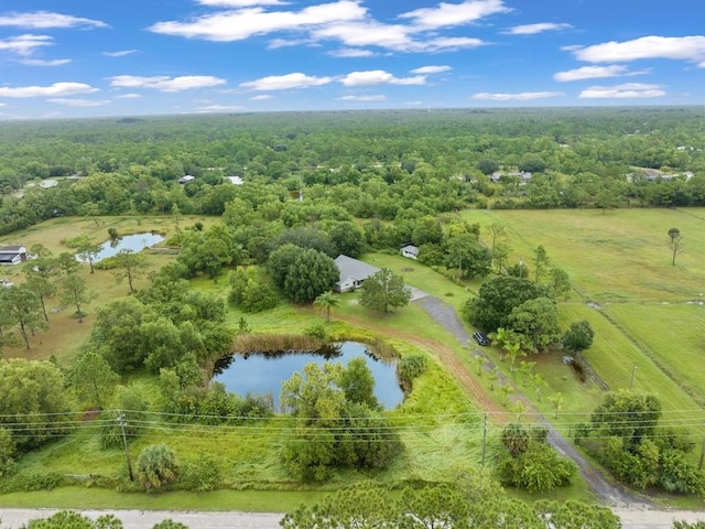 aerial view with a water view and a wooded view