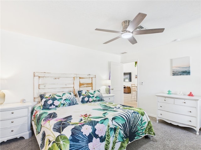 7965 105th Ave, Vero Beach, FL 32967 - carpeted bedroom with ceiling fan and connected bathroom