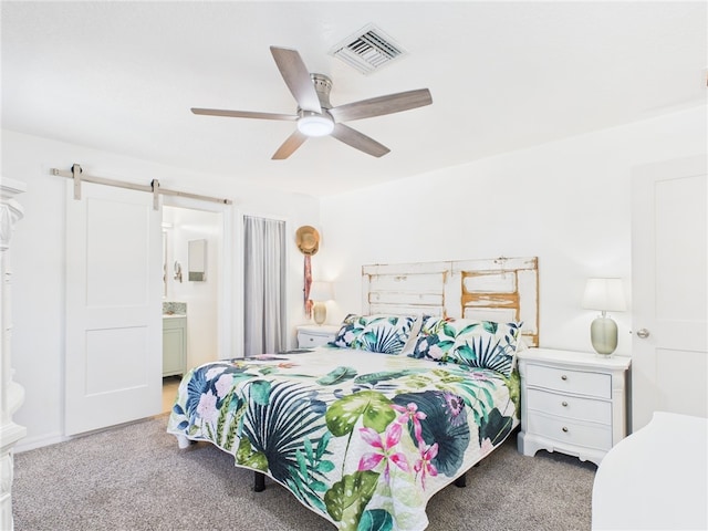 7965 105th Ave, Vero Beach, FL 32967 - carpeted bedroom with a barn door and a ceiling fan
