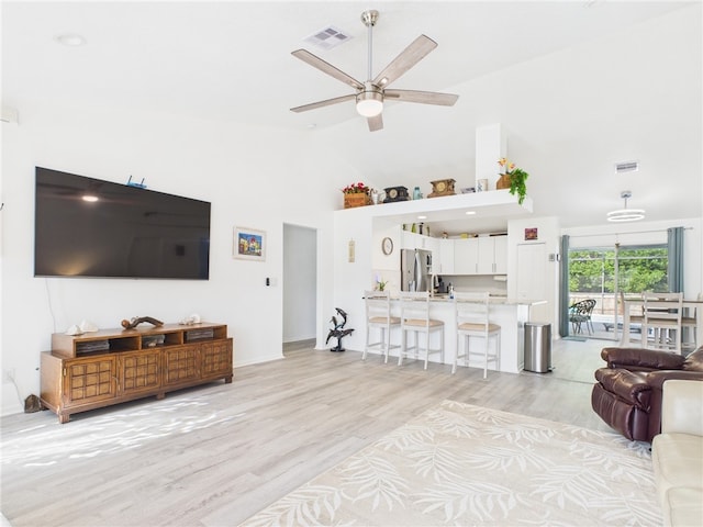 7965 105th Ave, Vero Beach, FL 32967 - living room featuring ceiling fan, light wood finished floors, high vaulted ceiling, and baseboards