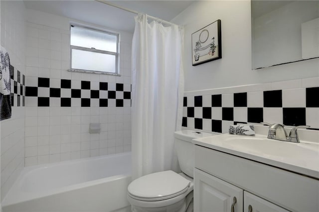 full bathroom with tile walls, toilet, vanity, and shower / bathtub combination with curtain