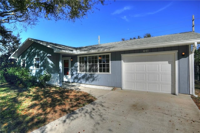 ranch-style home featuring driveway, a garage, and a shingled roof