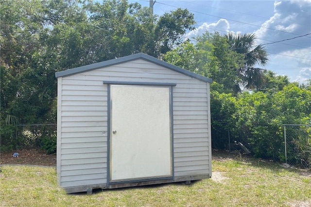 view of shed featuring fence