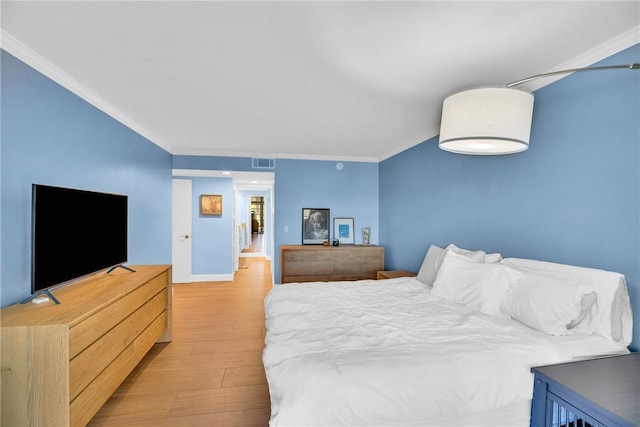 bedroom with light wood-type flooring and ornamental molding