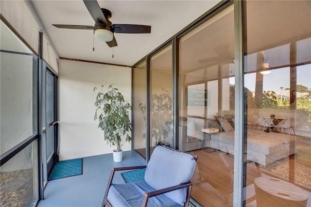 sunroom / solarium featuring ceiling fan