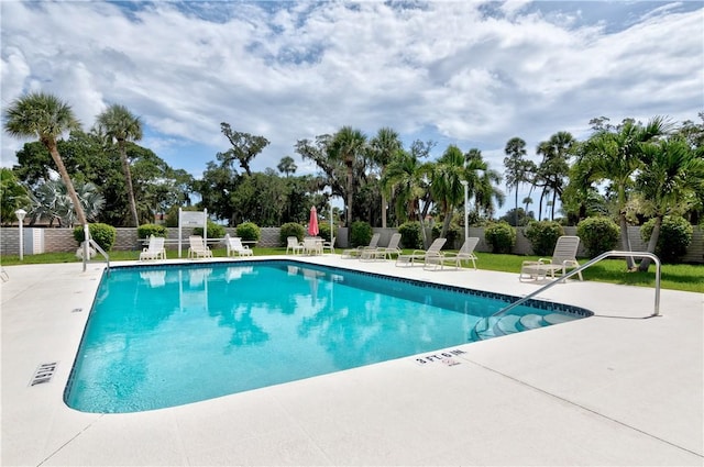 community pool featuring a patio area and fence