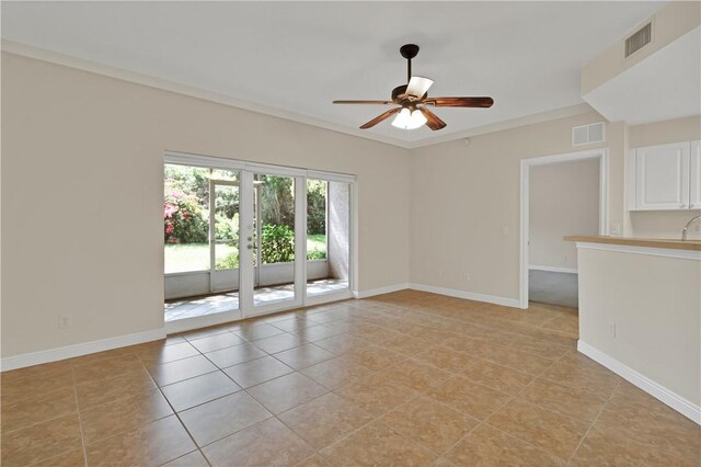 interior space with light tile patterned flooring, ceiling fan with notable chandelier, and baseboards