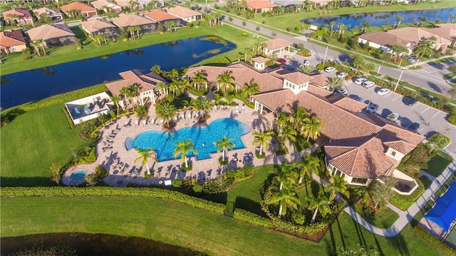 drone / aerial view featuring a water view and a residential view