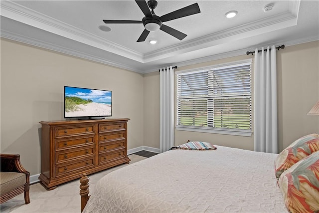 bedroom featuring crown molding, a raised ceiling, carpet flooring, ceiling fan, and baseboards