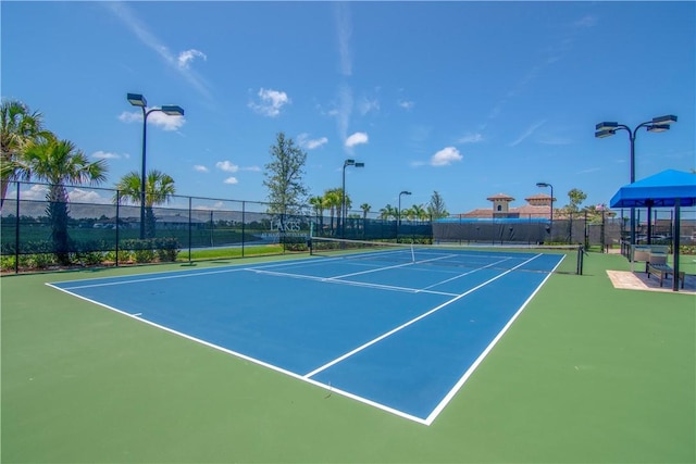 view of tennis court with fence