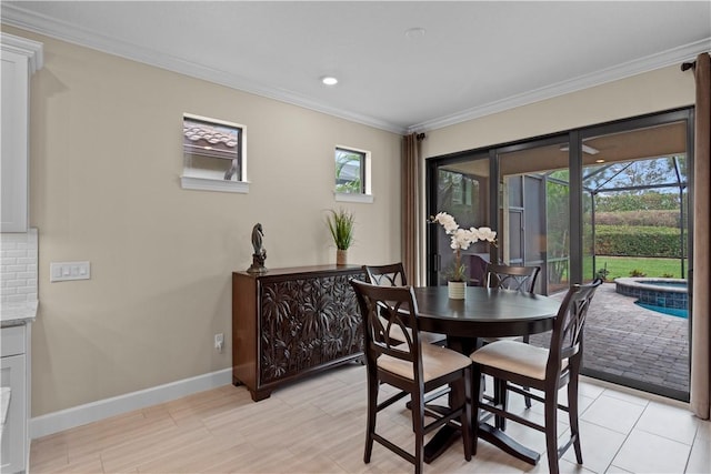 dining space featuring ornamental molding, a wealth of natural light, baseboards, and recessed lighting