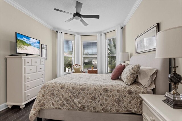 bedroom with multiple windows, ornamental molding, and dark wood-style flooring