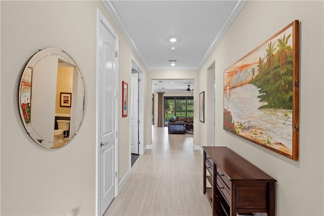 hall with baseboards, ornamental molding, and recessed lighting