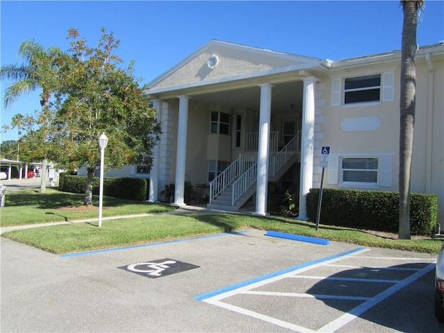 620 E Lake Jasmine Cir Unit 102, Vero Beach, FL 32962 - view of building exterior with uncovered parking and stairway